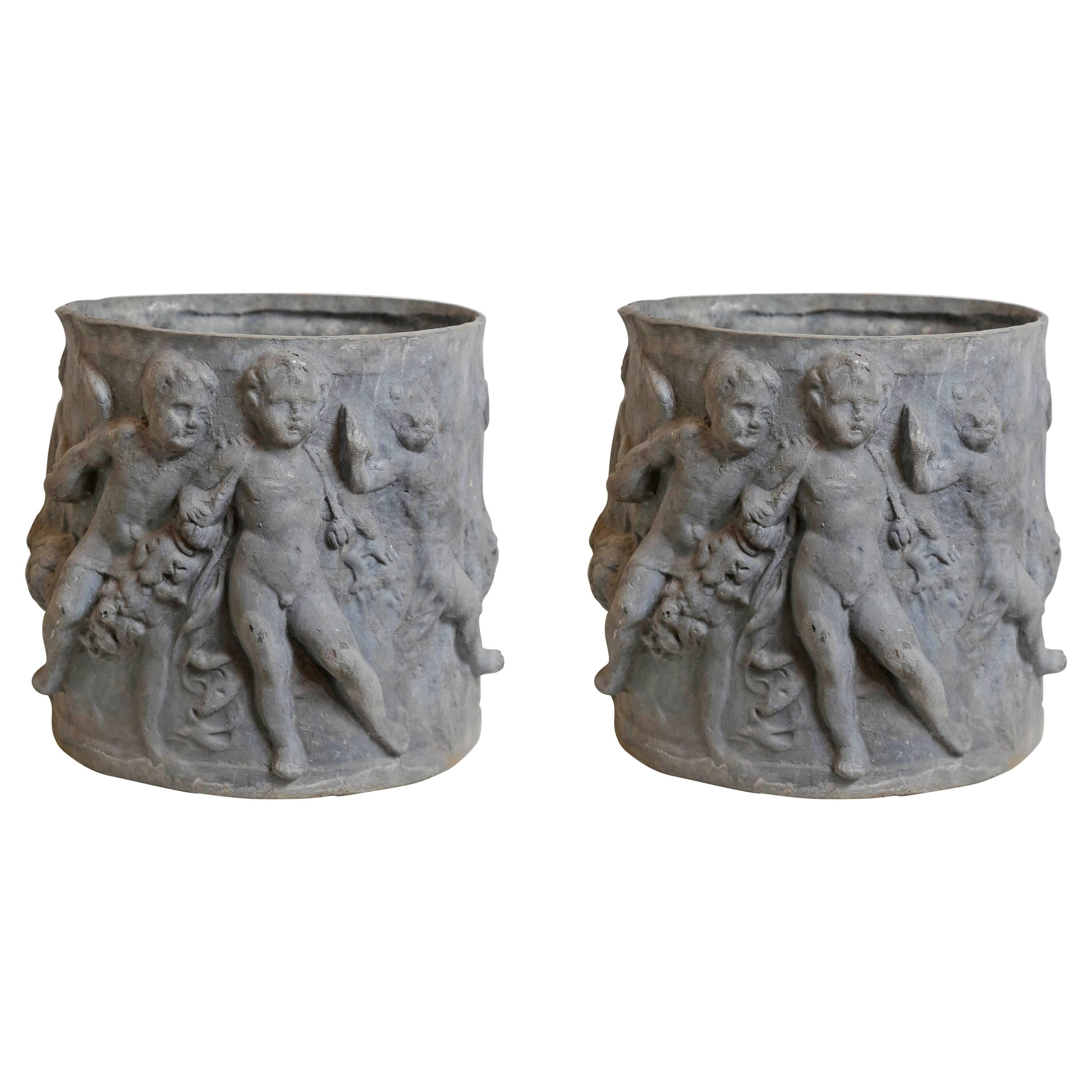 Pair of 19th Century French Lead Planters with Cherubs For Sale