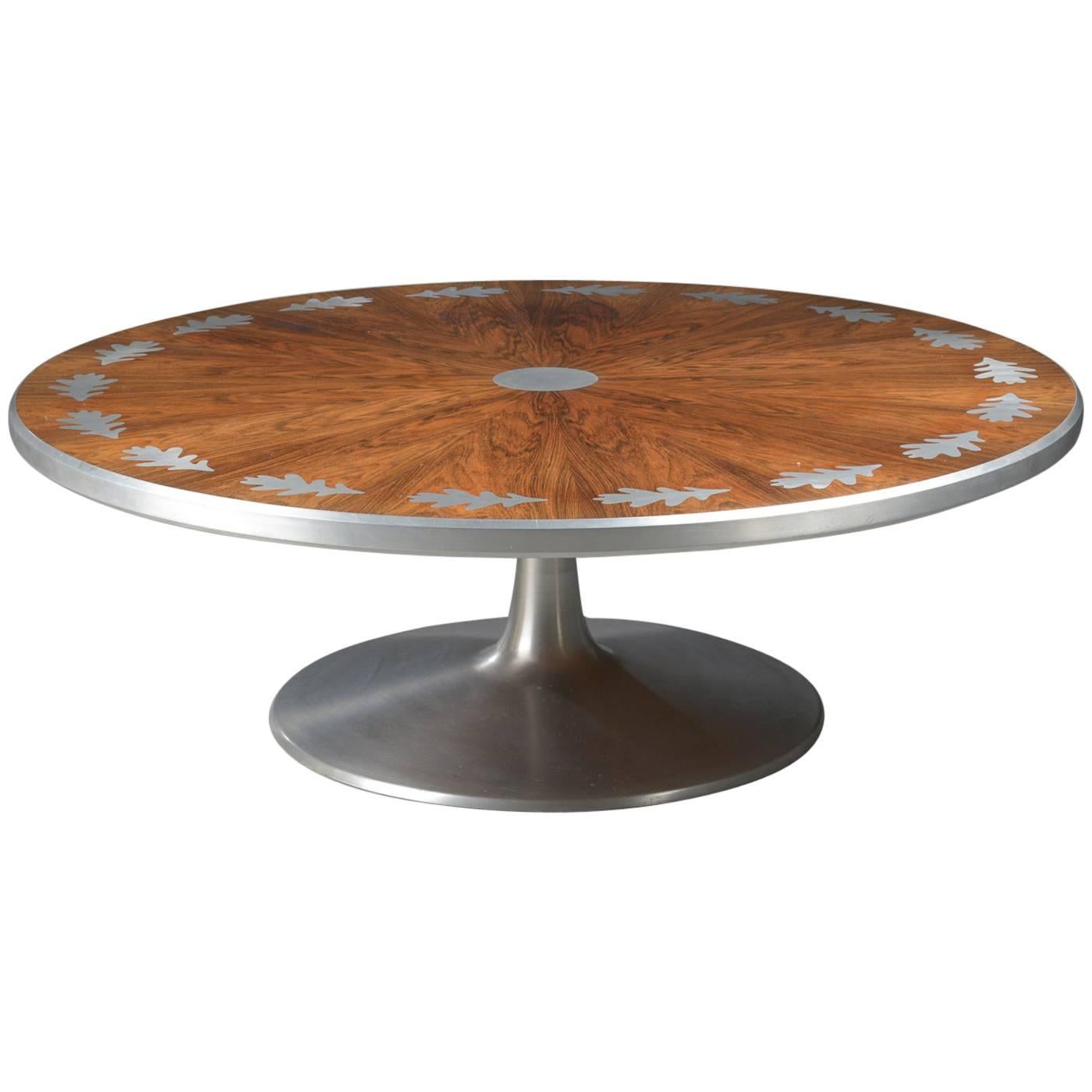 Absolutely stunning circular rosewood coffee table designed by Danish designer Poul Cadovius. Unique leaf inlay design in steel. Aluminum lipping middle and trumpet base. Produced by Cado.