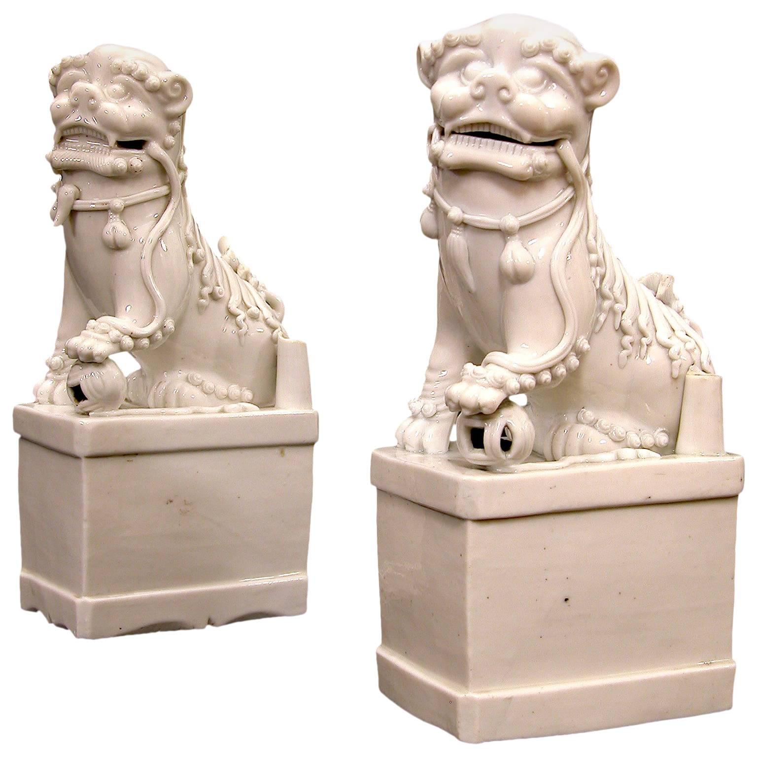 Two Chinese Porcelain Blanc de Chine Fo Dogs For Sale