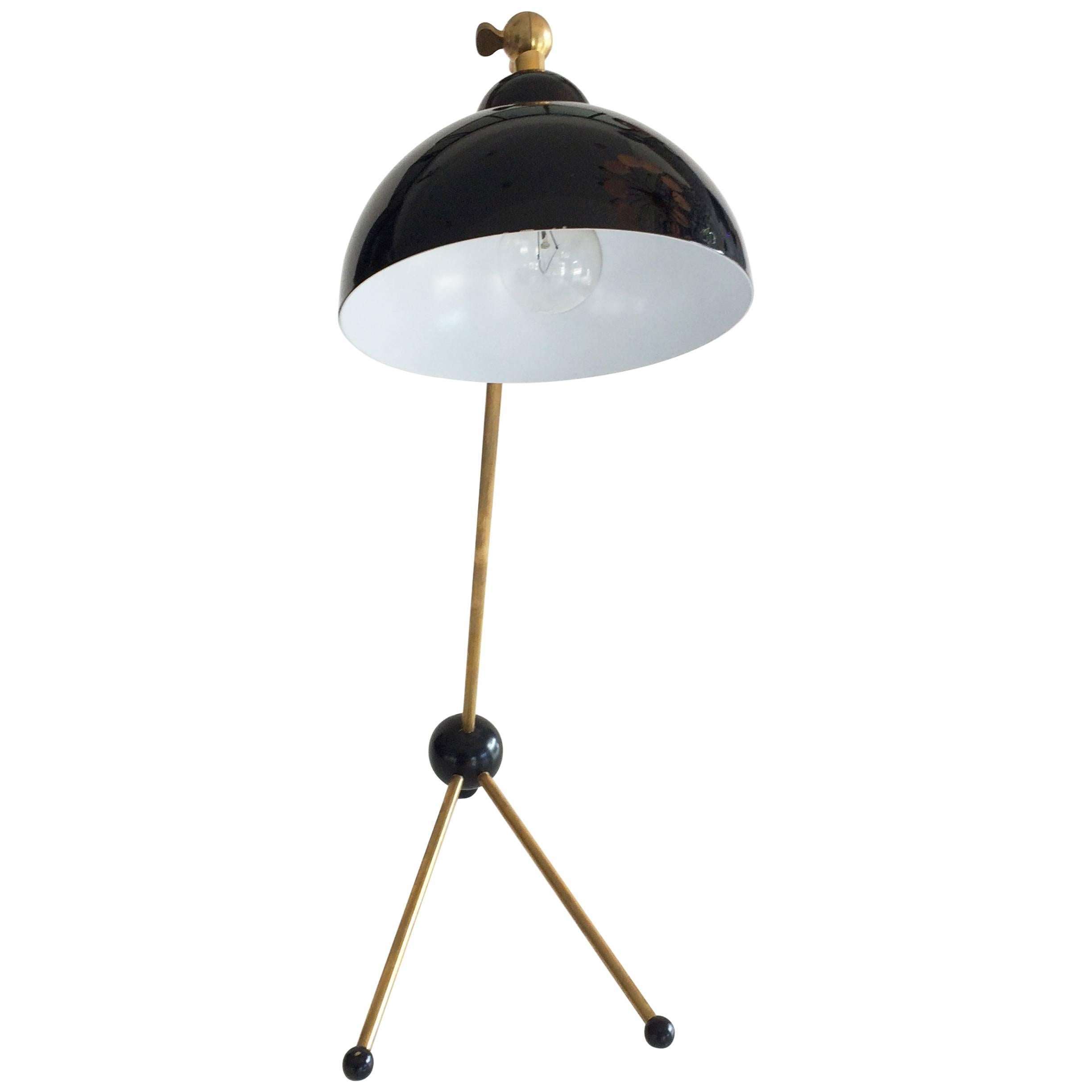 Very unique 1950s Italian Table Lamp with adjustable shade.  Combination of brass and black lacquered metal with three wooden bulbs.