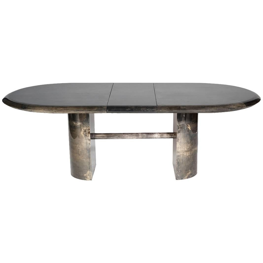 This elegant dining table by Aldo Tura features an organic, beautiful color palette of charcoal grays with natural undertones. The piece features two additional 16" leaves which extend the table from 76″ inches to 108" inches, for a large