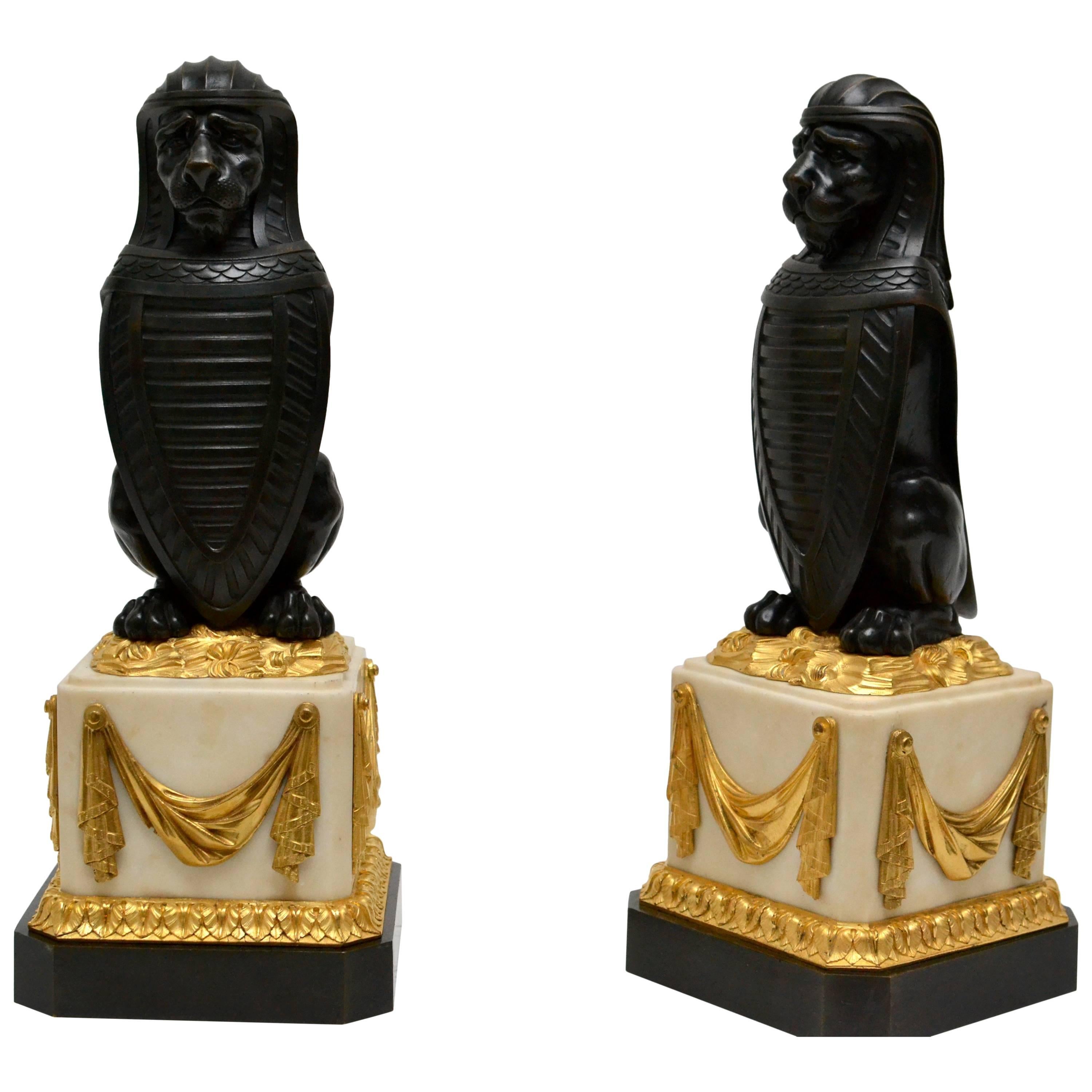 Pair of Patinated Bronze Lions with Shield on Ormolu-Mounted White Marble Bases