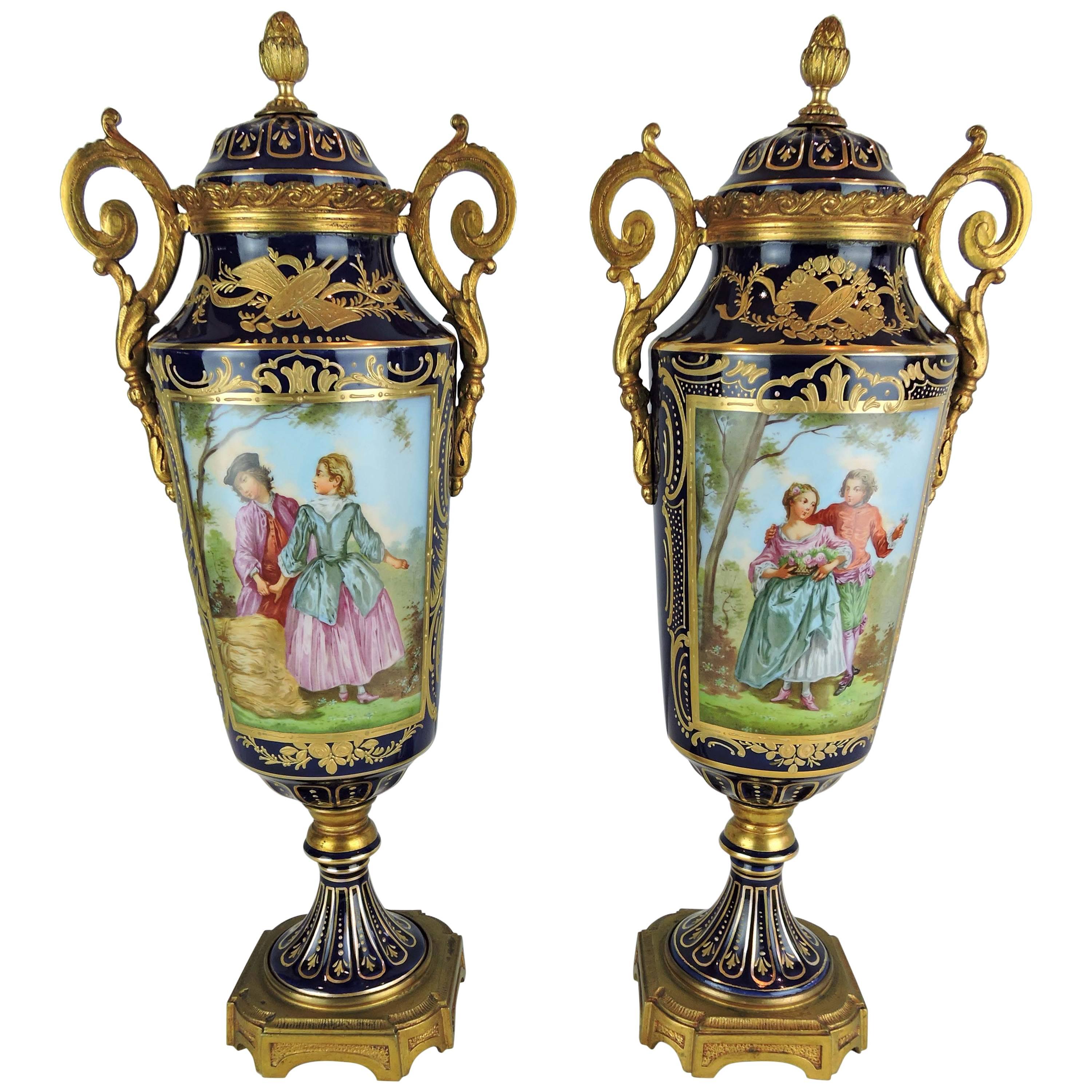 Pair of French Sevres Style Porcelain and Gilt Bronze Lidded Baluster Urns For Sale