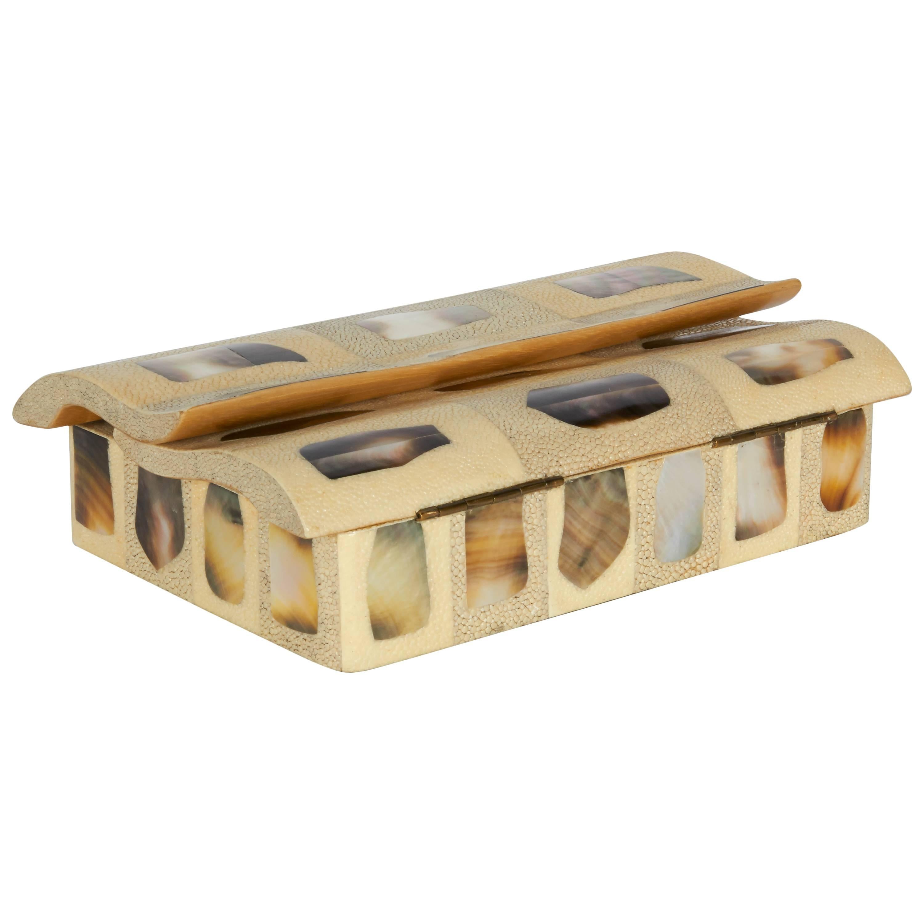 Exquisite decorative box featuring unique double lid top with overlapping wave formation.  Comprised of alternating crème and grey shagreen, creating a geometric pattern, each with exotic mother-of-pearl inlays. Lids open to reveal black velvet