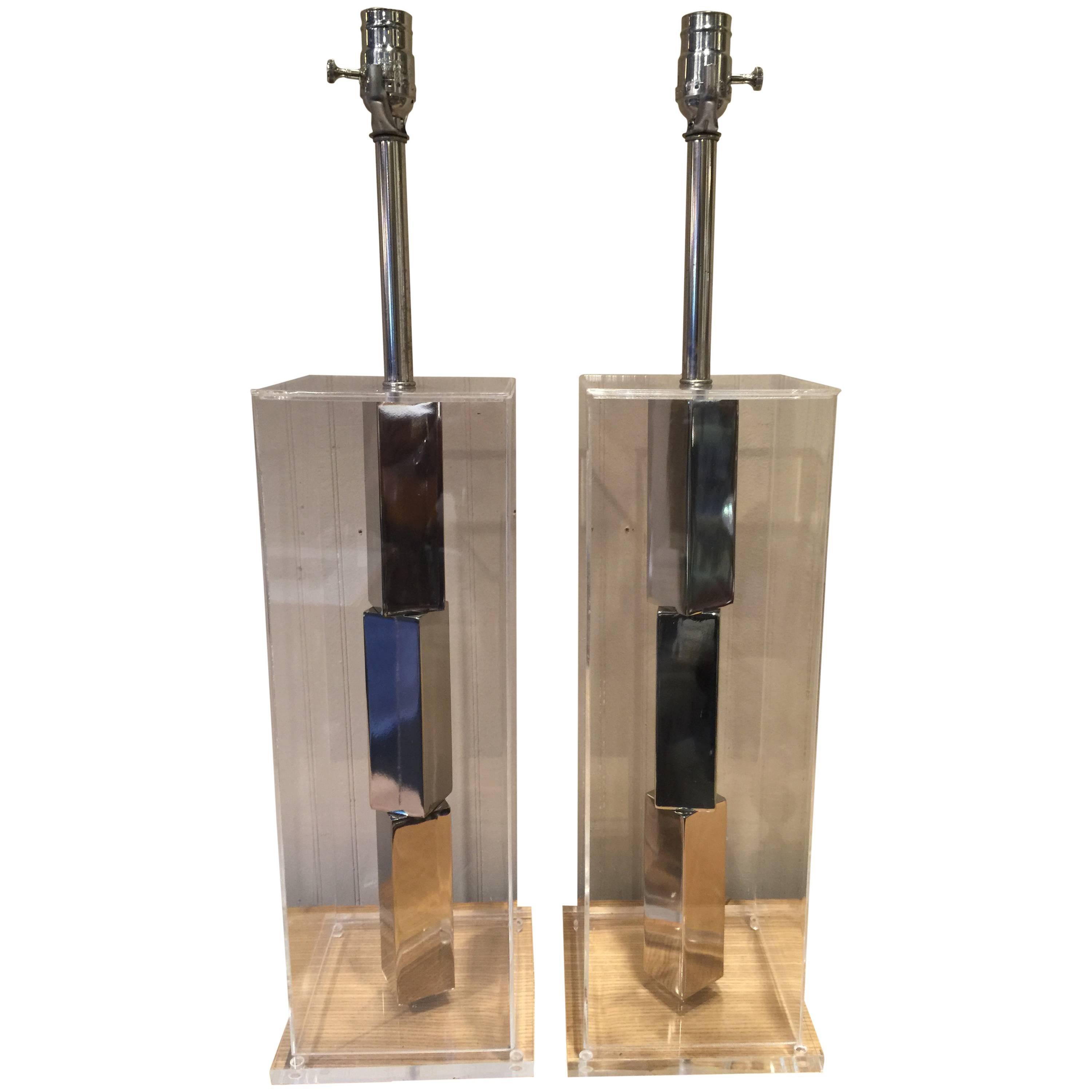 Pair of architectural Lucite lamps, each one a rectangular cube with interior stacked chrome blocks, in the style of Sol LeWitt. Shades are for display purposes only.