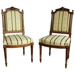 Pair of French Carved Walnut and Parcel-Gilt Chairs in the Louis XVI Style