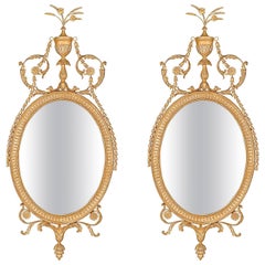 Pair of Oval Mirrors in the manner of Robert Adam