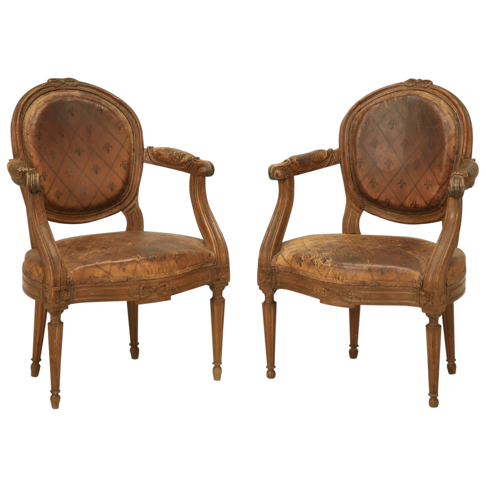 French Louis XVI Style Armchairs in Original Leather with Unusual Fleur de Lis For Sale