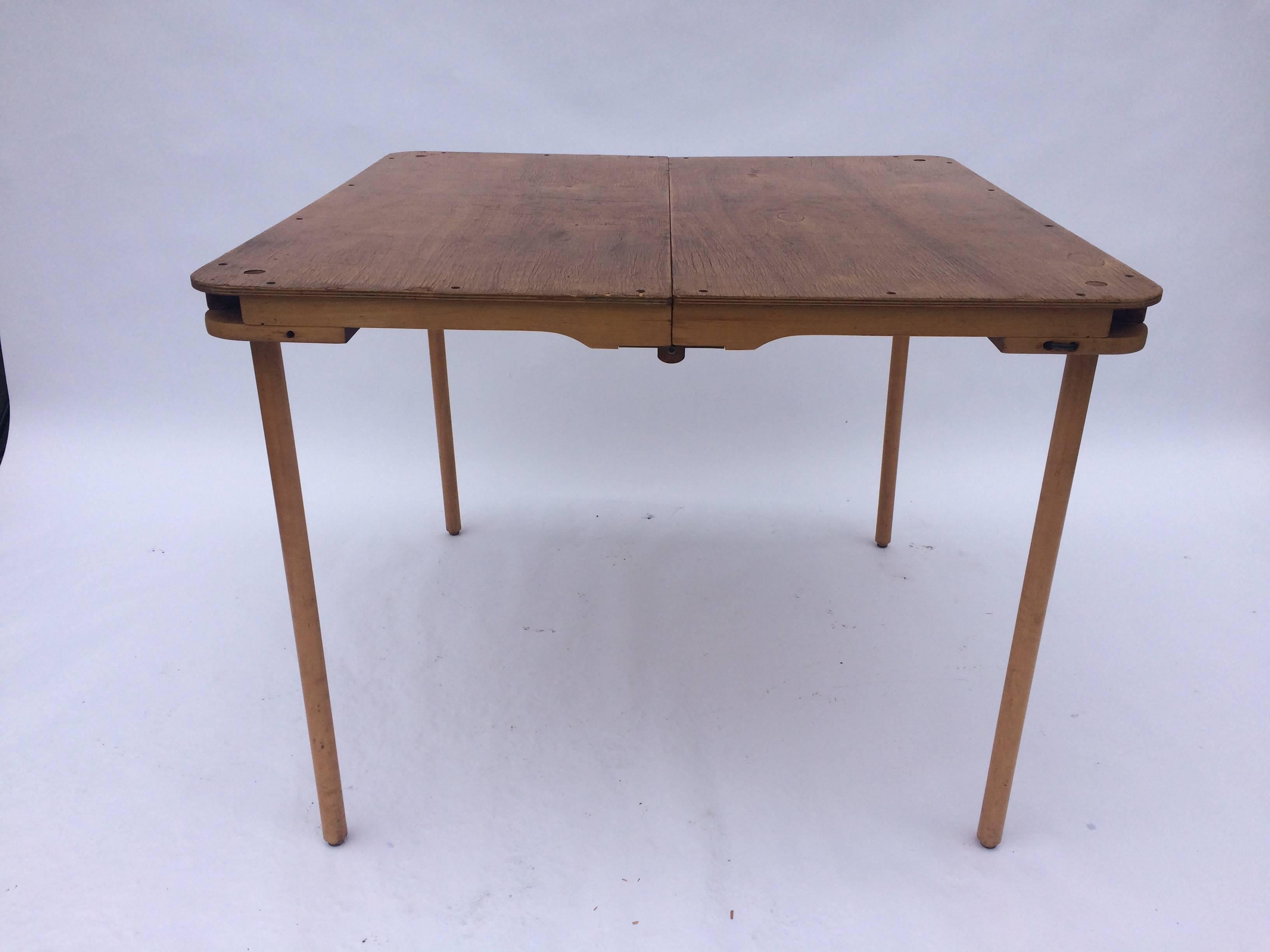 Plywood table and plywood and canvas stools by Barry Simpson, manufactured by Dirt Road in Waitsfield, Vermont between 1976-1984. Marked on underside of seat: ROOSTER BY DIRT ROAD / WAITSFIELD, VT. One stool was perhaps replaced earlier than the