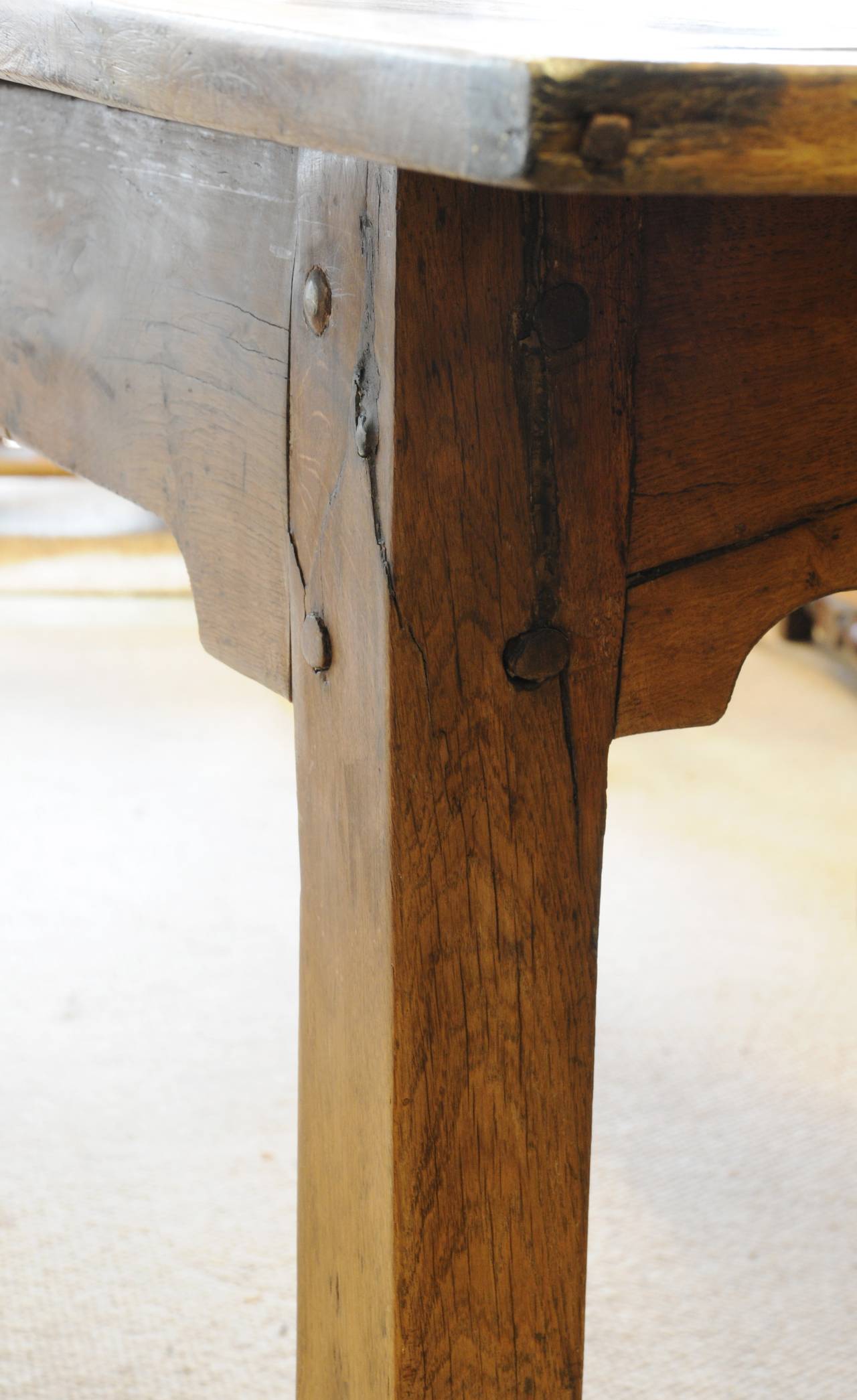 Pale oak farm table, the three plank figured top with cleated ends, raised on four straight legs united by plain friezes, the front frieze with a drawer.  England, Devon. Second half 18th century
Formerly in Maunsel House Somerset, the property of