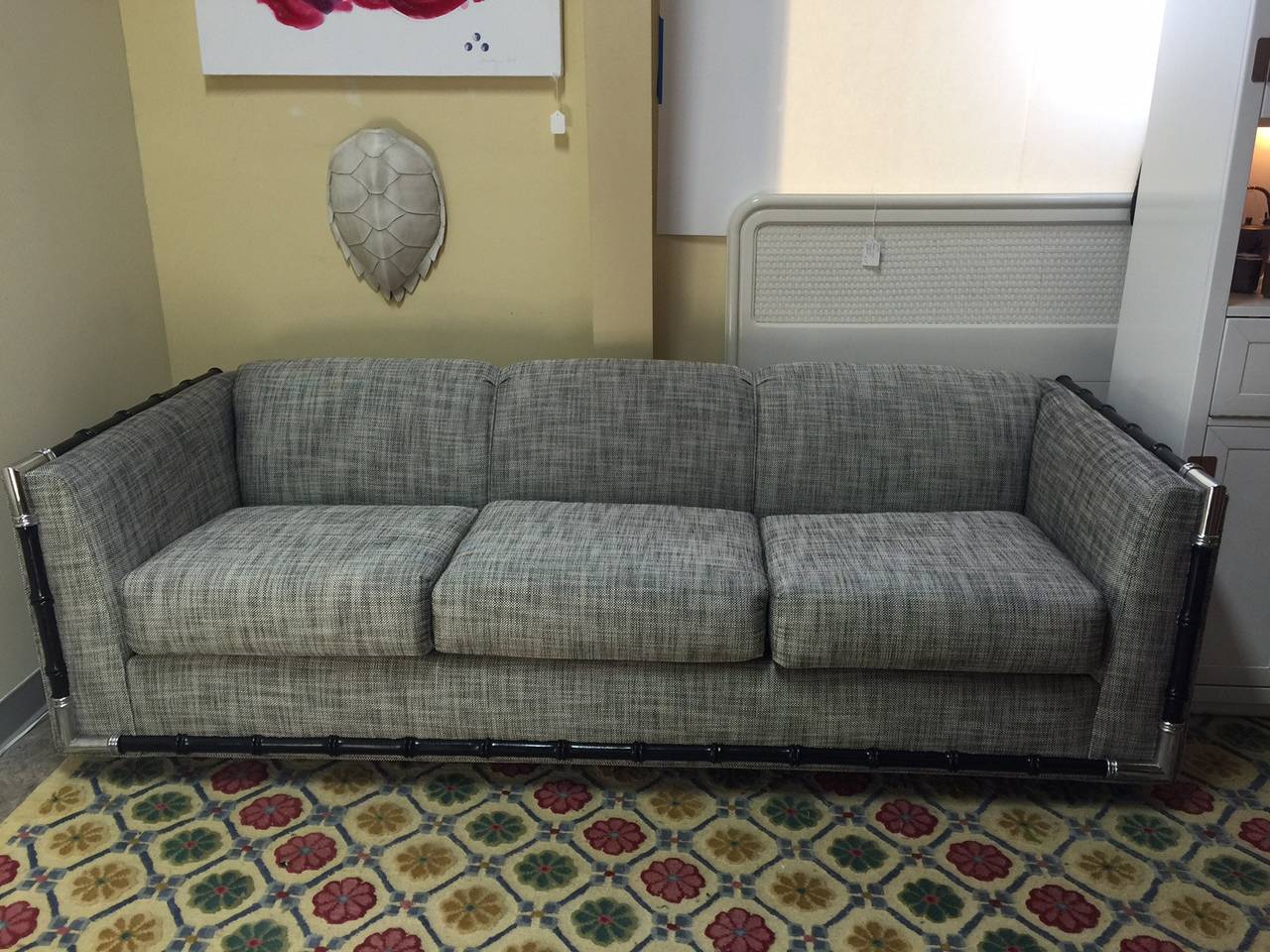 This sofa is a Classic example of MCM style and it has been completely refurbished: new springs, new cushions, new upholstery, and a new coat of paint on the fax bamboo trim. The chrome trim at the corners is in excellent condition. The fabric is a