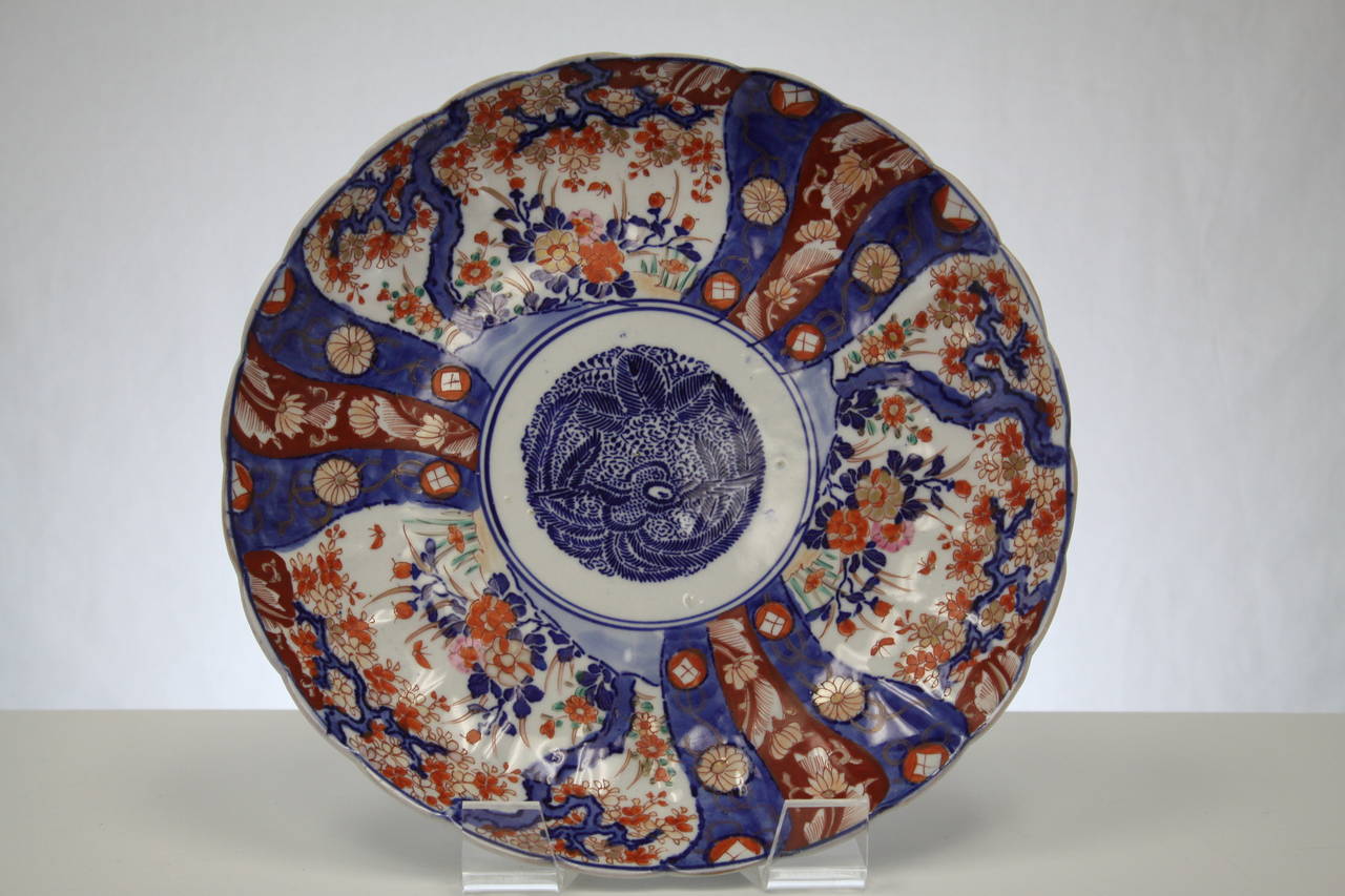 Wonderful Japanese Imari charger, circa 1820. Rich blue and red colors. Three scenes on the front and decorative images under glaze on rear of piece. Excellent condition.