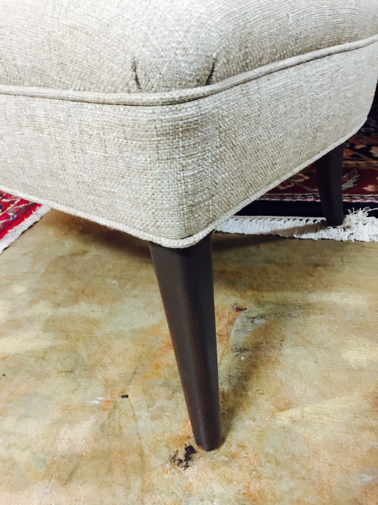 This vintage chair has been completely refurbished, and is reupholstered in a slighly nubby oatmeal colored fabric (see close up).   It has a sweet shape to the back and is petite enough to fit in any small space as an extra chair or in a bedroom.