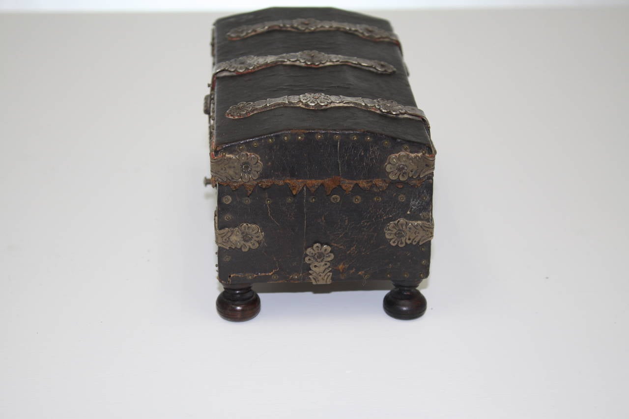 Period 18th century leather cover wooden box with sterling strapping and copper rivets, late 1700s. Leather over wood. Sterling silver straps and paper lined interior.