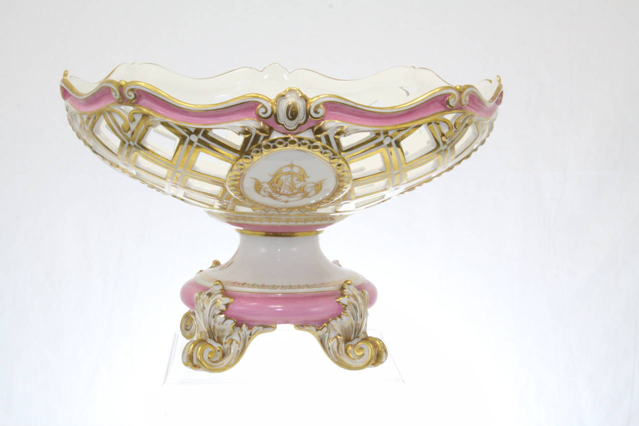Old Paris Pink Pompadour Centerpiece Bowl with wonderful 24 kt Gold Crest on all four sides.  Basket weave design outlined in 24 kt gold paint.  Has two marking on base that is photographed.  Outstanding piece with no losses or damage.  Exceptional