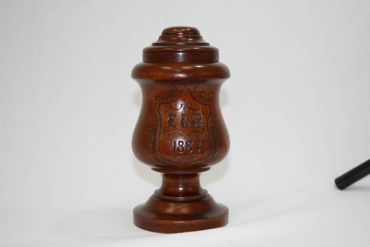 1883 Belgium mahogany money jar (box) monogrammed with initials and the date 1883. The top has a slot for coinage to be placed.
