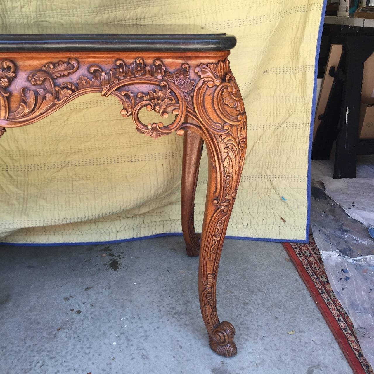This gorgeous console table is in impeccable condition and is labeled Maitland Smith. The carving is detailed and perfect. The date of manufacture of this table is not known. It is marked Maitland Smith on the underside of the table. It is without