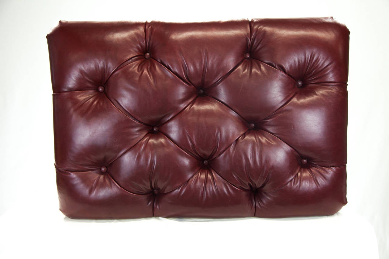 Perfect as a ottoman or coffee table this item is newly upholstered and rich grain Oxblood Leather.  Beautiful Deep Rich Bold Red Leather great for the family or formal spaces. Very versatile. Double rows of Brass Nail heads completes this ottoman.