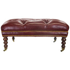 Large Tufted Oxblood Leather Ottoman with Traditional Casters