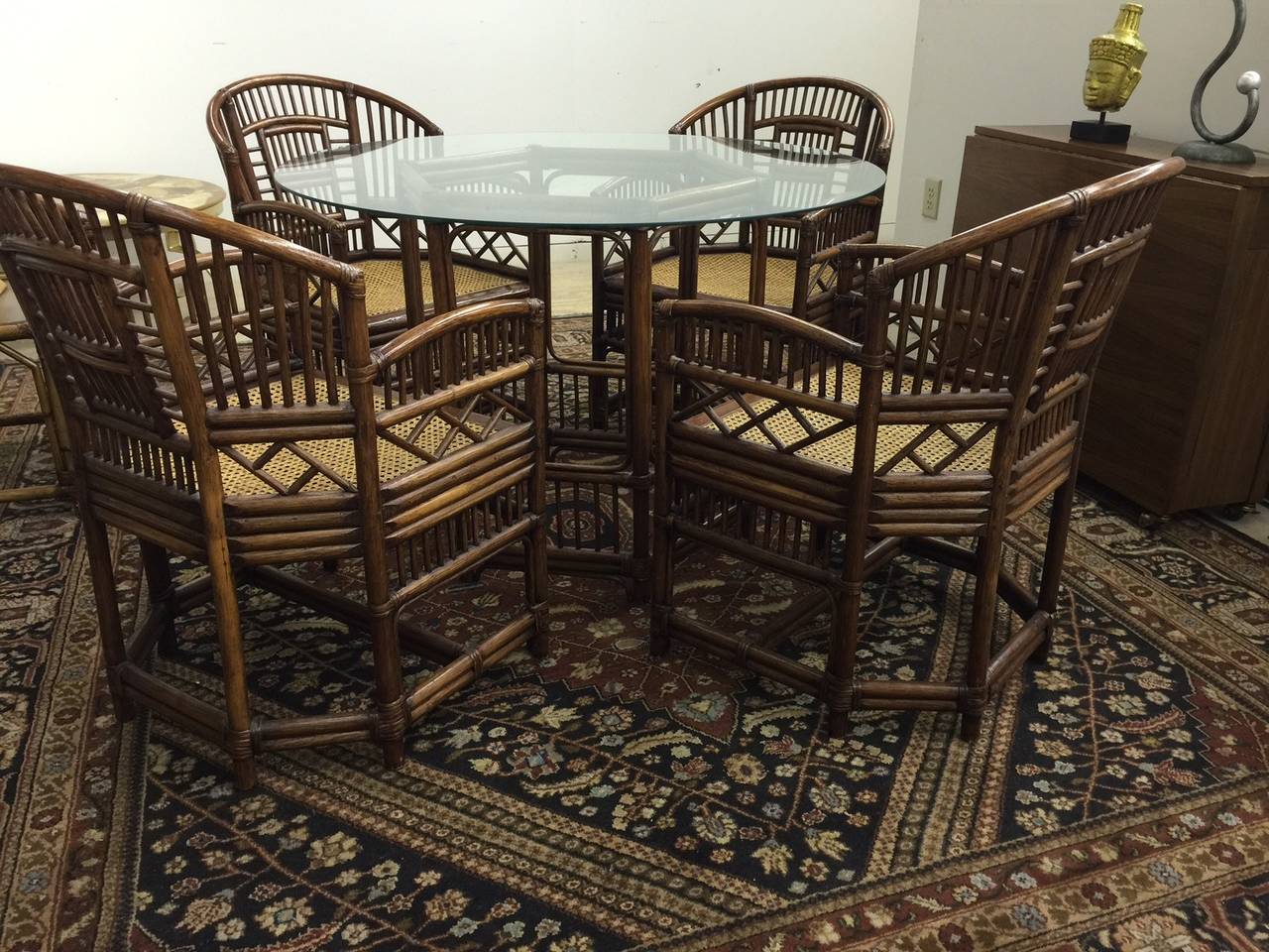 Perfect for a breakfast area or the porch, this vintage 5 piece set is in great condition. Caned seats on the four chairs with no wear to the seats.  The glass top sits on a matching base.  The table base is 27