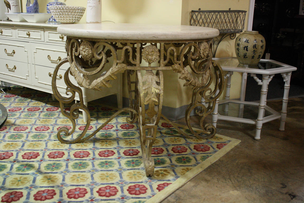 This table would make a great entry foyer table or an occasional table. The base is ornate gilded metal; the top is a 1.5 inch piece of honed or unpolished limestone.