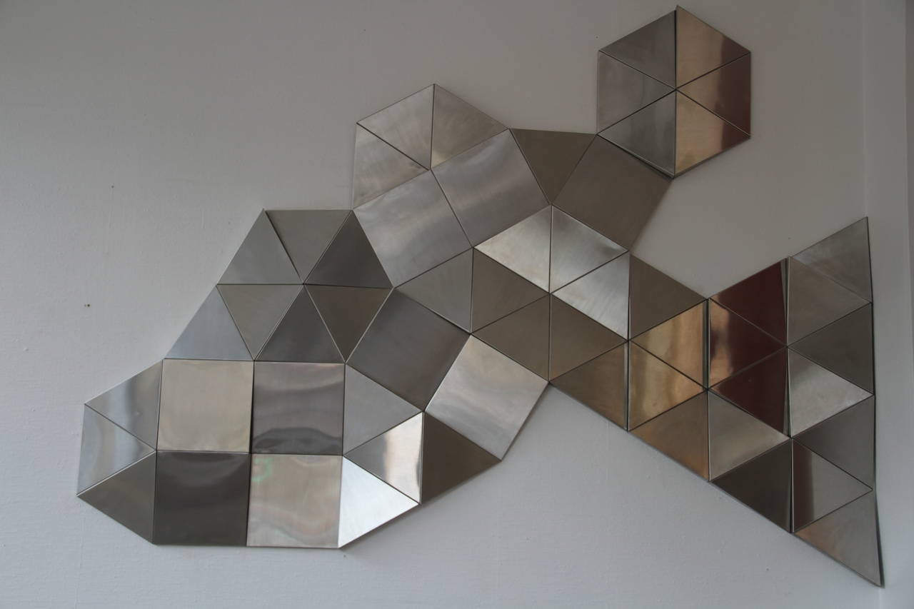 Rare modular wall sculpture composed by 57 pieces of metal.

You can compose it like you want; on the photos you can see some examples in the original documentation.

57 pieces on the picture (nine squares and 45 triangles)
Squares and