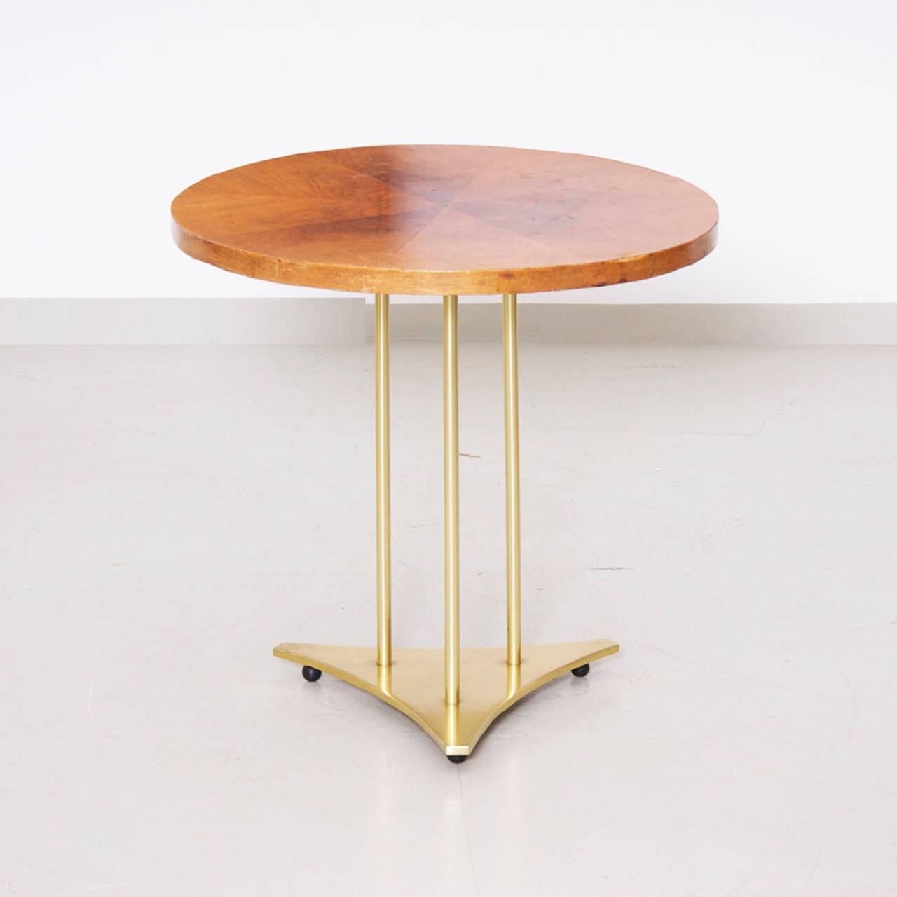 Erwin Lambeth coffee table with solid brass base and wooden top that is cut in eight parts.