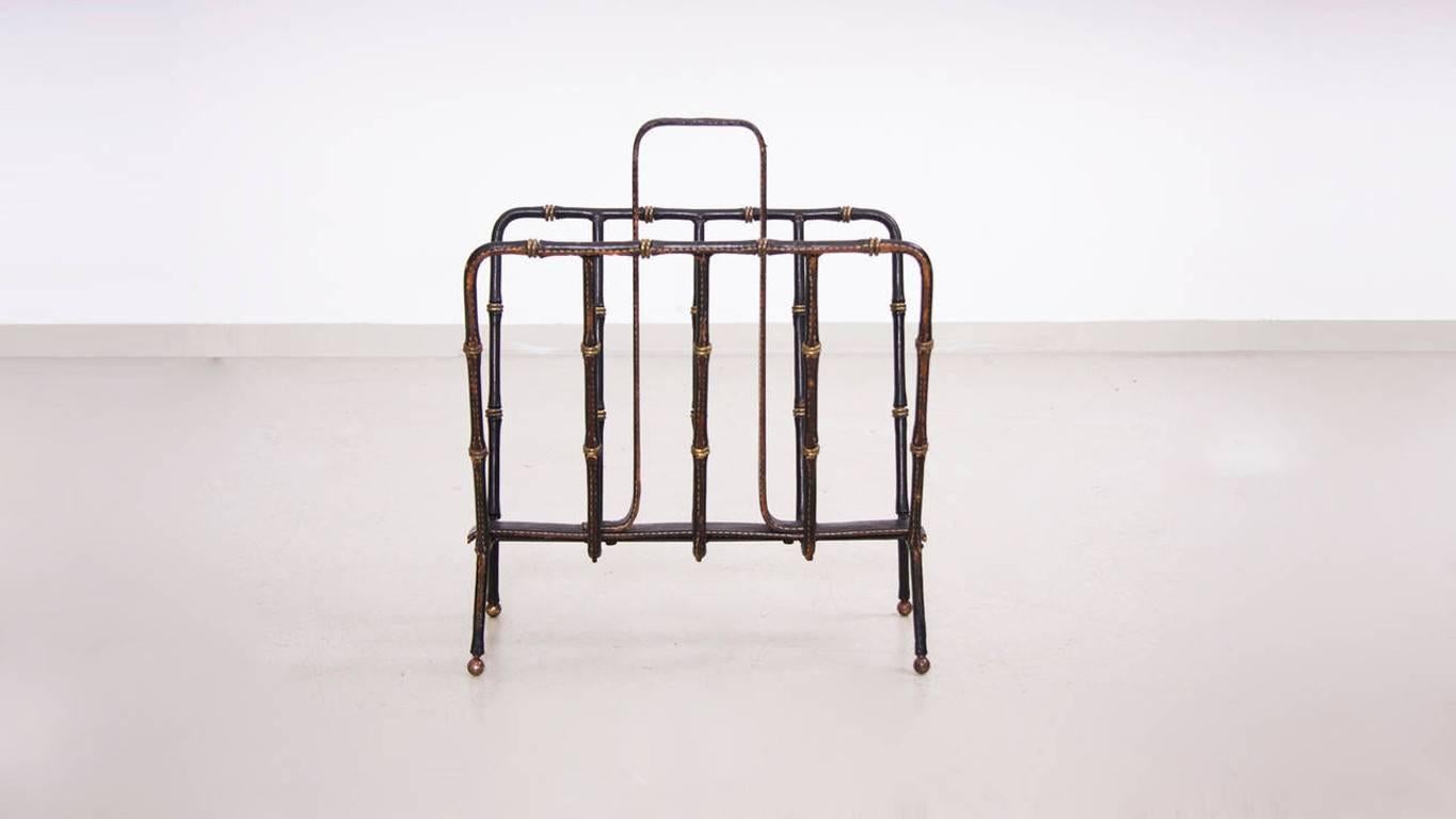 Jacques Adnet iron and leather magazine rack in very good condition.