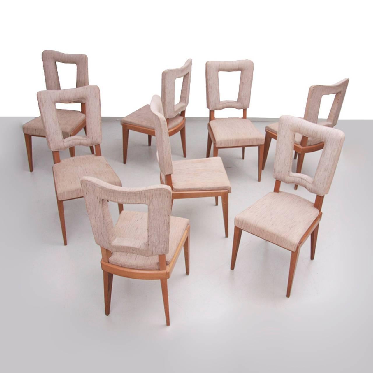 Set of eight high end production chairs in the manner of Jean Royère in original condition. Heavy solid construction. Reupholstery advised. That is something that could be done in our atelier or you can do it yourself.