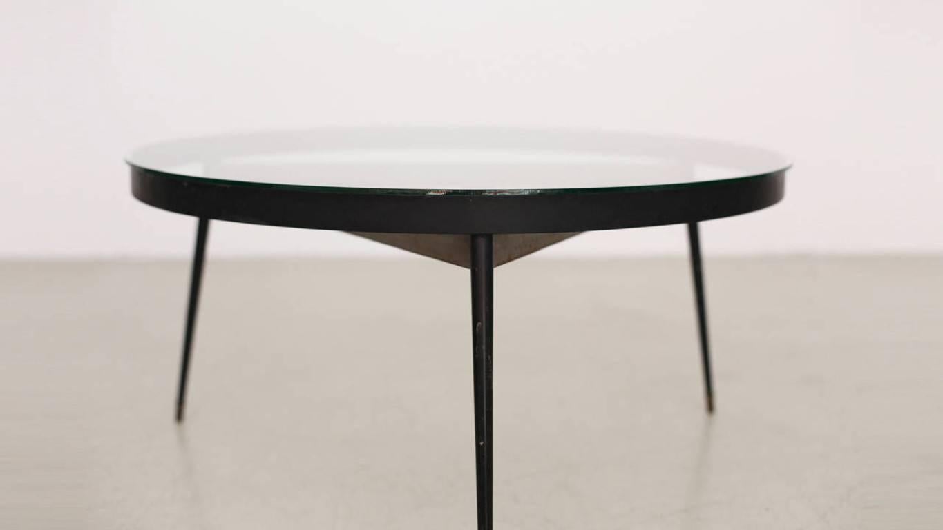 French round tripod table with a glass top and brass feet. In an excellent condition.

 