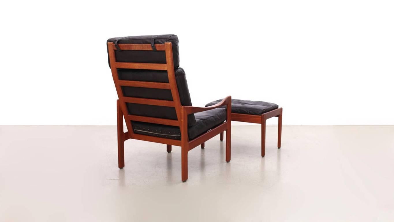 Teak and dark brown leather Lounge Chair and Ottoman by danish designer Illum Wikkelsø for Niels Eilersen. The leather shows some mild patina.

In addition, we have a pair of these highback Illum Wikkelsø chairs in black leather with one matching