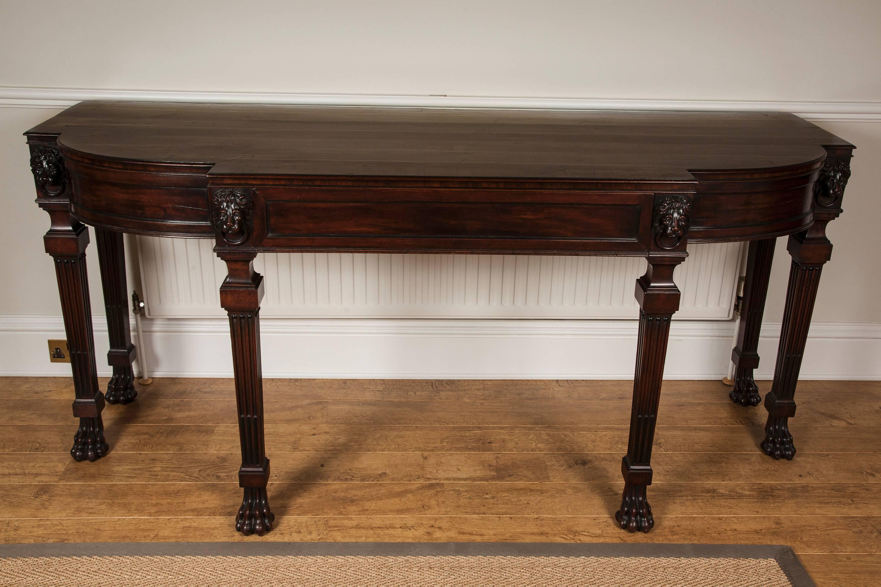 A very elegant console, hall or serving table. The cross banded top above frieze drawer on six square section blocked and tapering reeded and fluted legs topped with carved lion mask motifs and terminating in paw feet.
Of particularly good