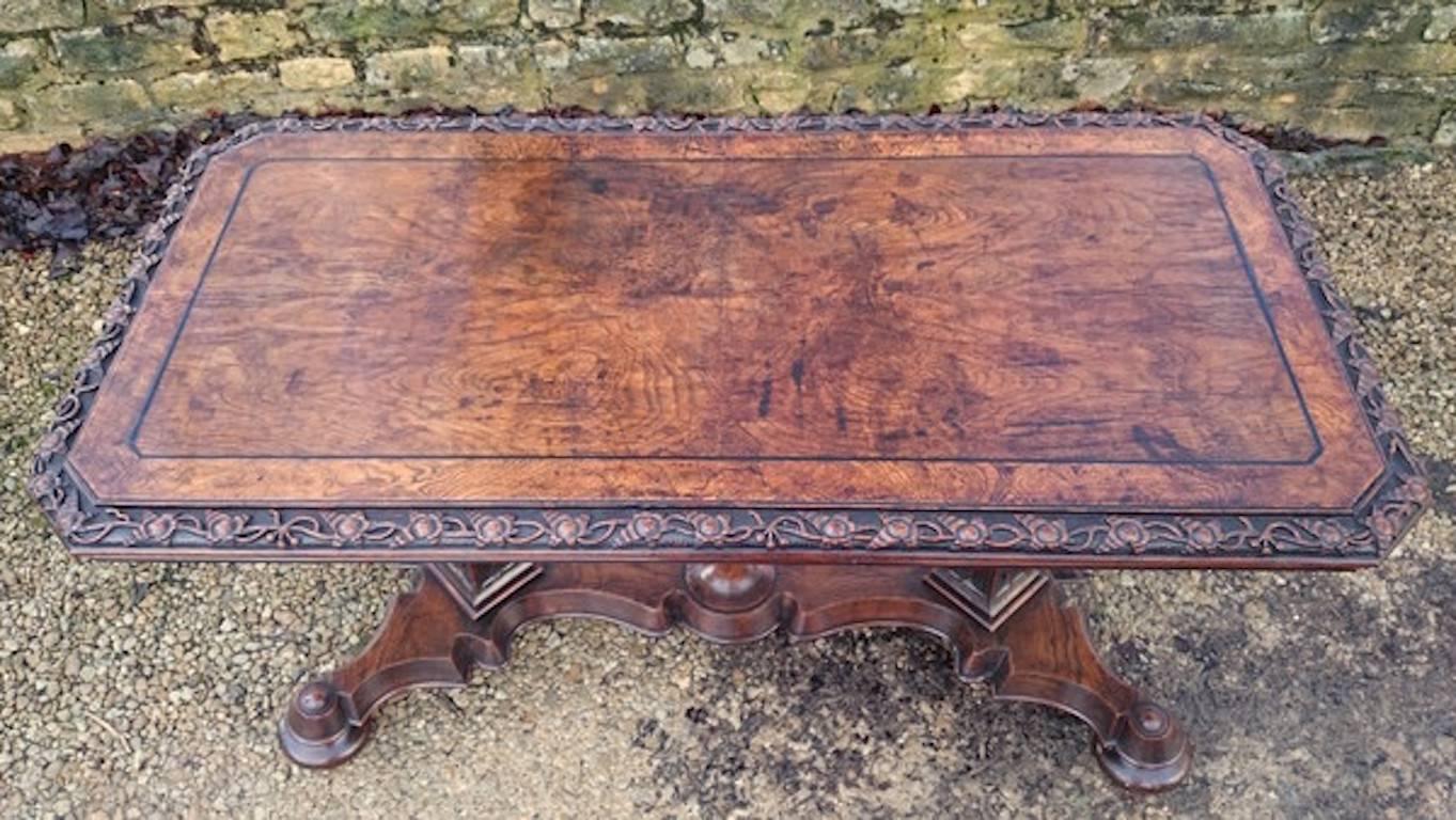 Very rare 19th century writing table of particularly fine form standing on two slender supports with very thin platform base. The base is carved with c-scrolls, there are turned bun feet with casters hidden beneath. The supports are square in