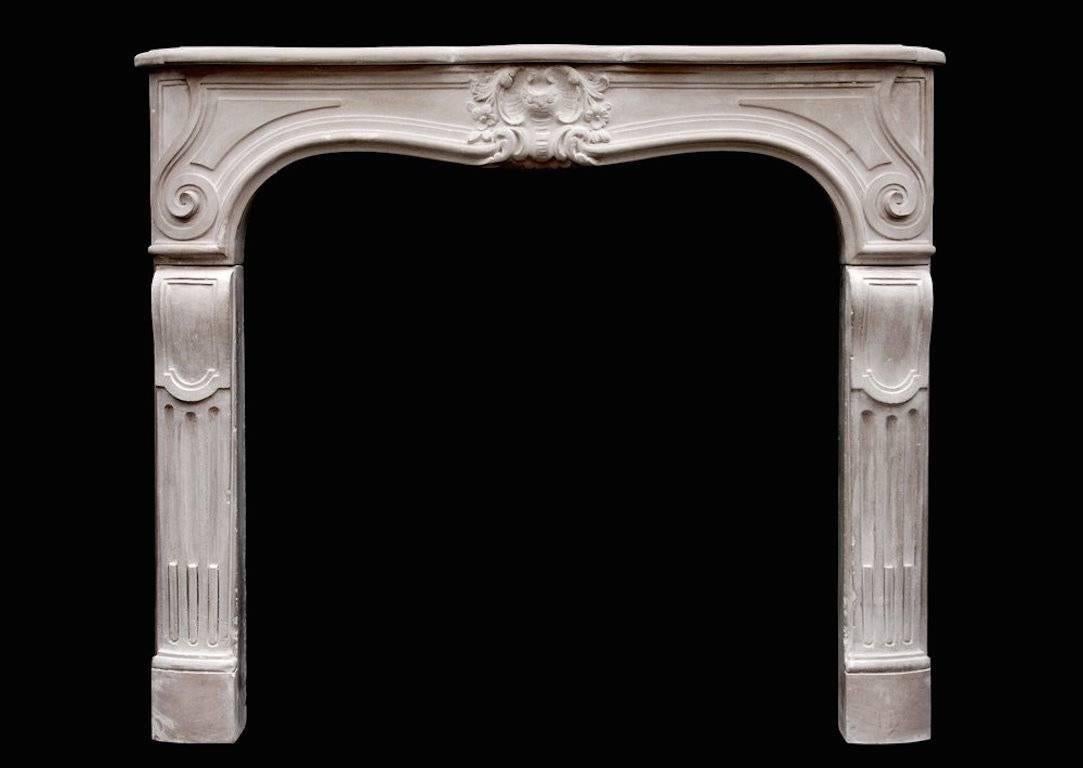 A late 18th century French limestone Louis XV fireplace with carved leaf motif to centre and scrolled design to end of frieze. The jambs with stop flutes and panels above.

Measures: Shelf width - 1353 mm 53 ¼ in.
Overall height - 1156 mm 45 ½