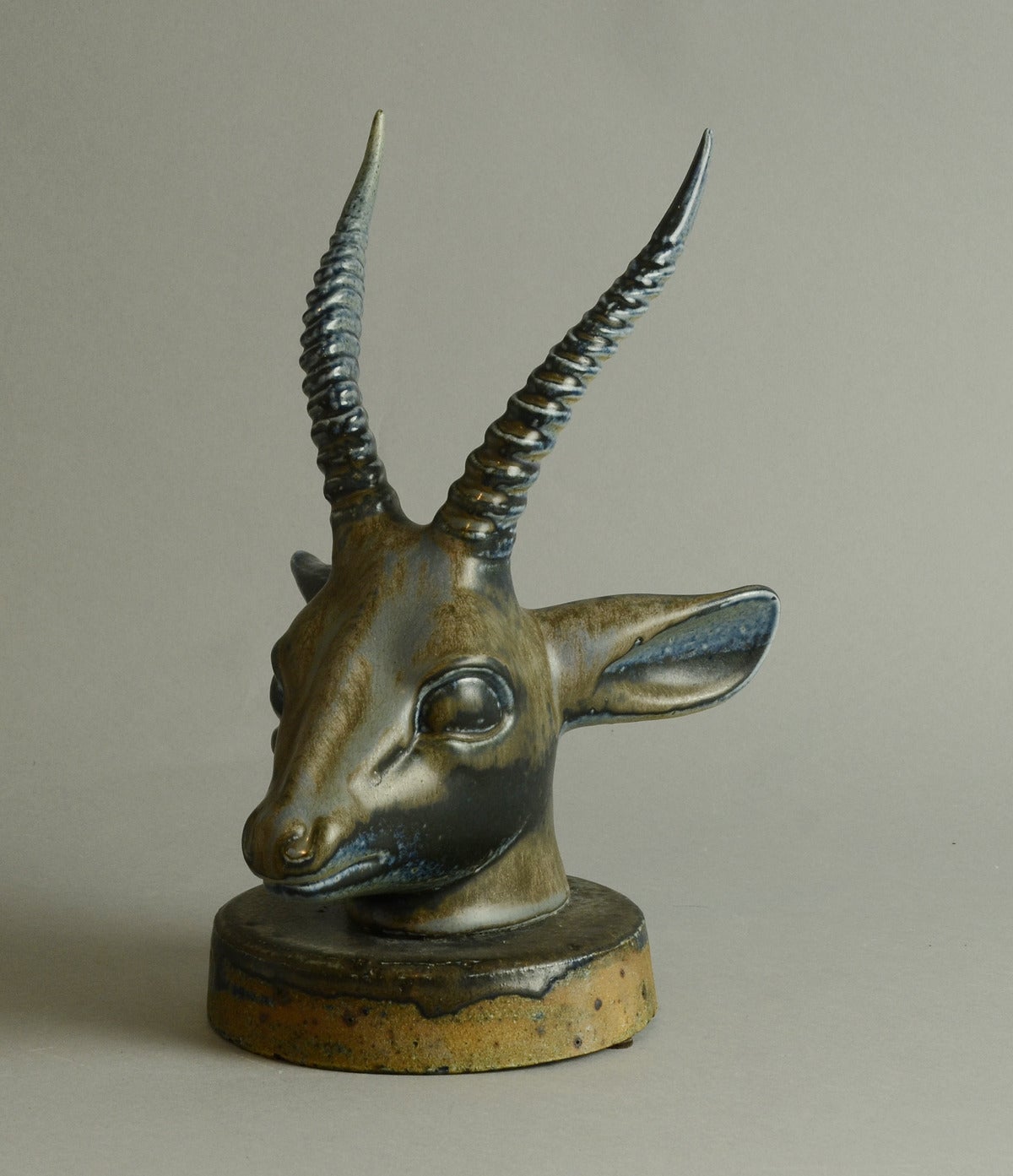 Axel Salto head of antelope. 

Axel Salto for Saxbo. 

Unique stoneware figure of an antelope head with blue and brown haresfur glaze, 1931.
Measures: Height 12