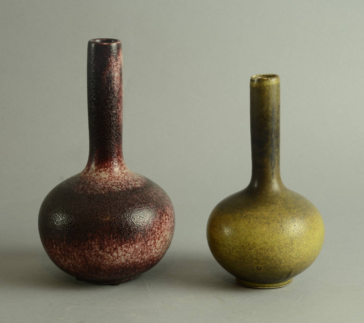1. Stoneware bottle vase with orange-peel textured oxblood glaze, 1960s.
Height 9 1/2" (24cm) Width 5 1/2" (14cm) No. N7606

2. Gourd-shaped bottle vase with solfatara glaze, 1964
Height 8" (20cm) Width 4 1/2" (11.5cm)No.