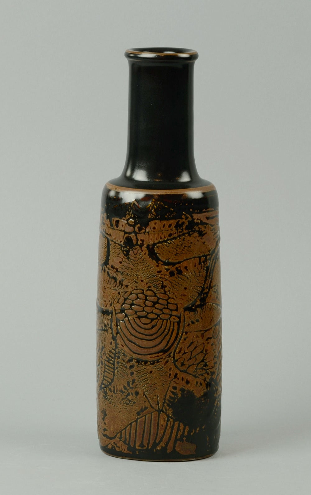 1. Unique stoneware bottle vase with city landscape in relief, reddish brown glaze, 1960.
Height 10
