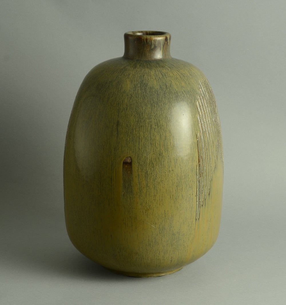 Monumental stoneware bottle vase with golden brown haresfur glaze with carved decoration to body, 1950s.