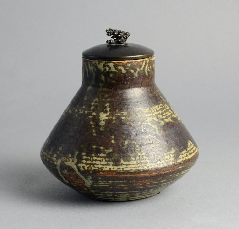 Unique stoneware jar with bronze lid and matte sung glaze in dark reddish brown, cream and gray, 1930.