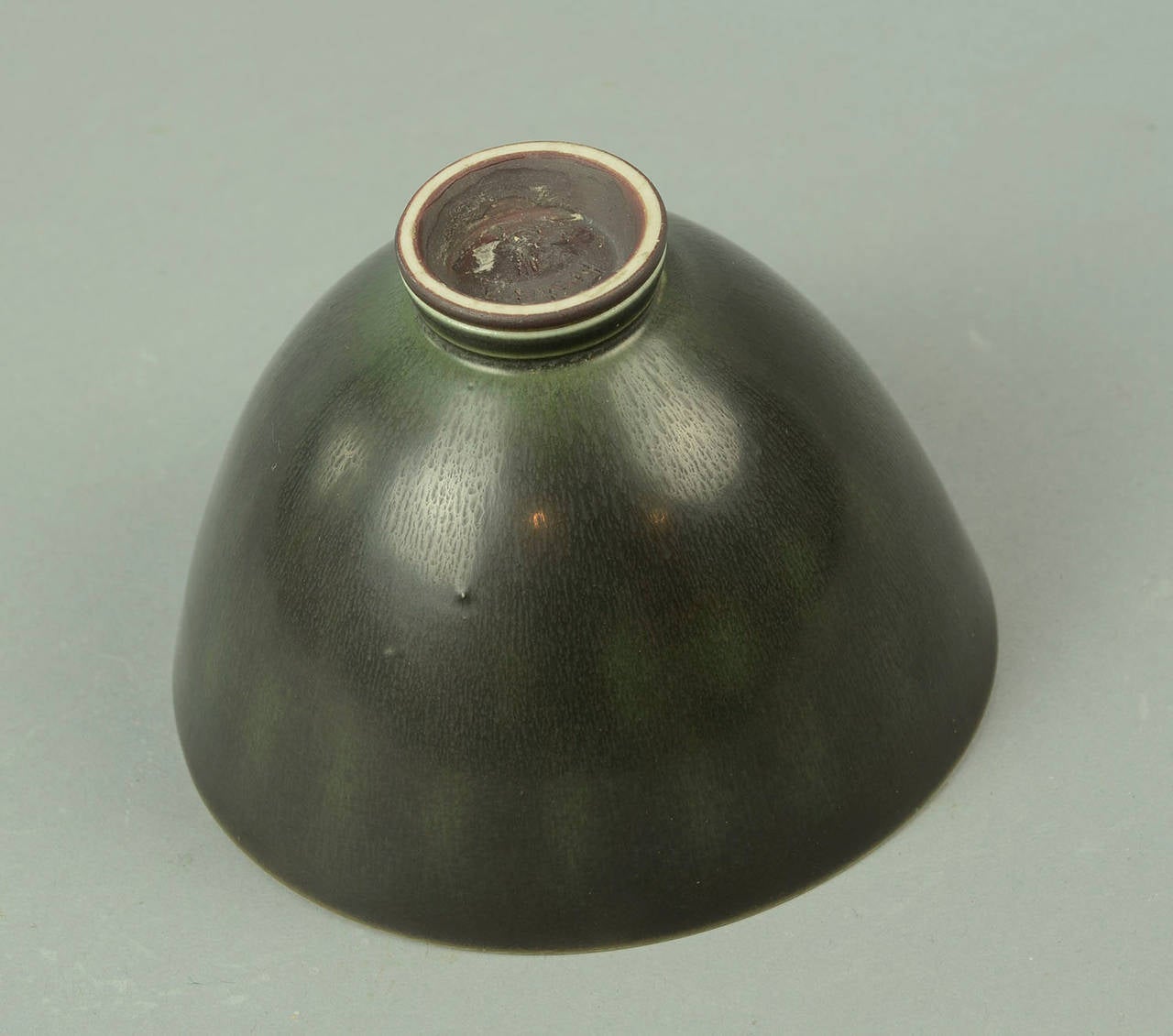 Unique stoneware bowl in dark green and black glaze, diamond pattern to interior and exterior, 1956.
 A1283