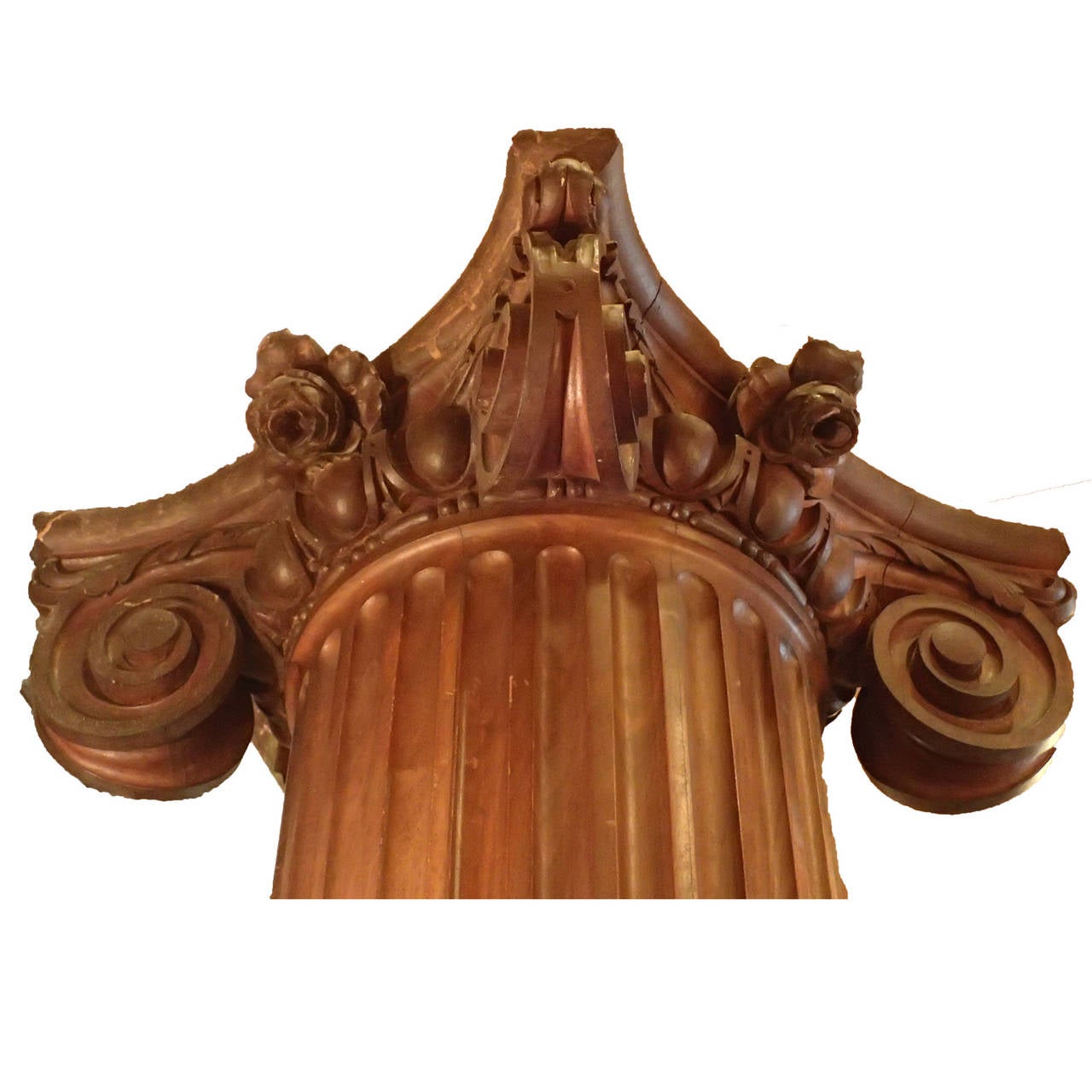 Wonderful antique, English fluted walnut carved column adorned with a capital with beautiful volutes and an egg and dart design topped with a flower. 
Walnut Corinthian column possesses natural flair and festive character that has set it apart