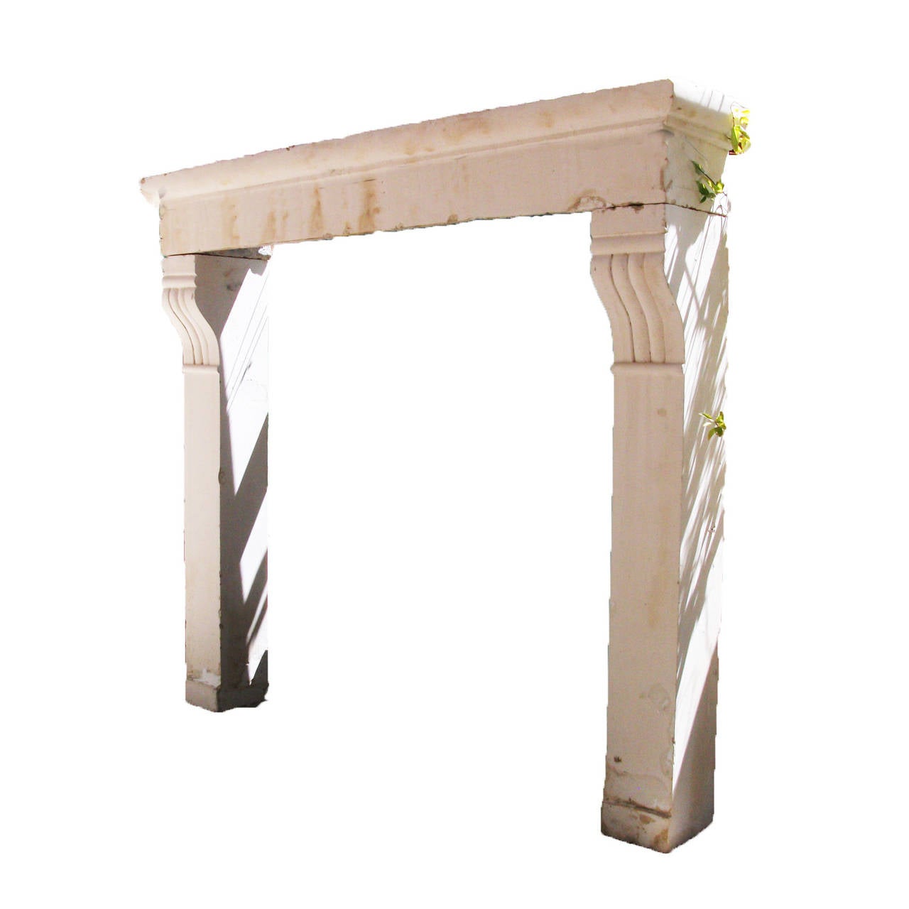 Antique French Limestone fireplace. This countryside style fireplace is handcrafted in limestone. This limestone fireplace is in good condition and from the 19th century. Very traditional style mantel with carved curved accents at the top of the