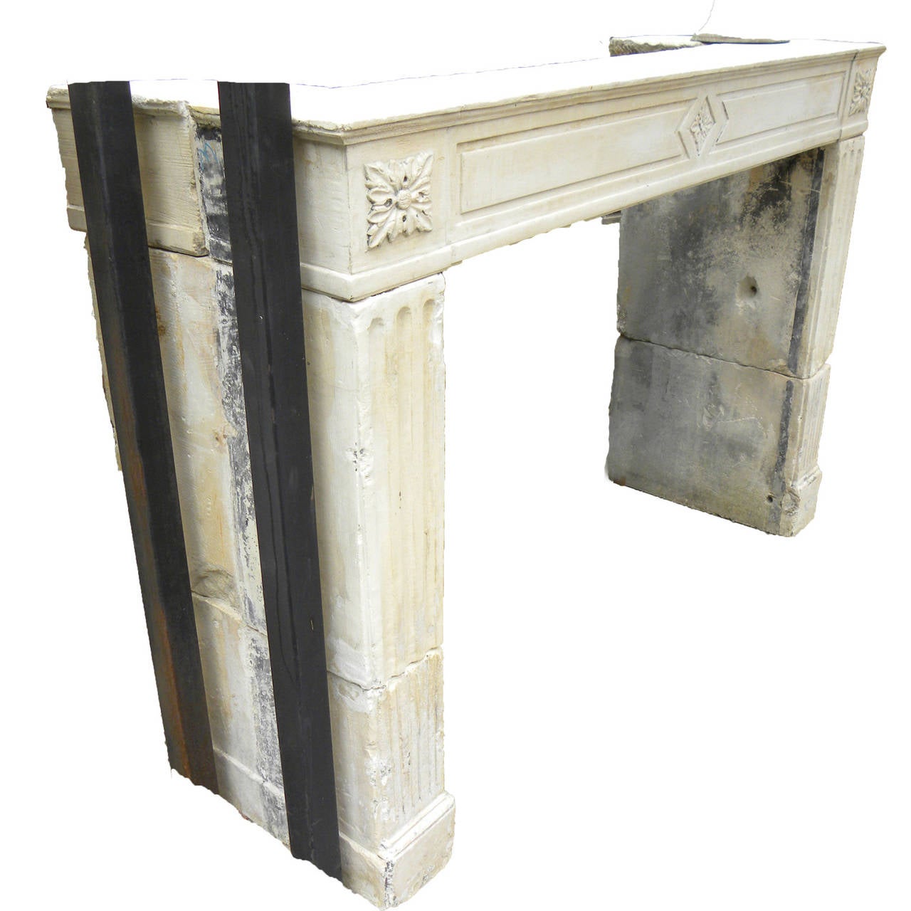 Antique French Limestone fireplace. This Louis XVI style fireplace is handcrafted in limestone. This limestone fireplace is in good condition and from the 18th century. Beautiful Mantel with carved accents along the face of the Mantel as well as the