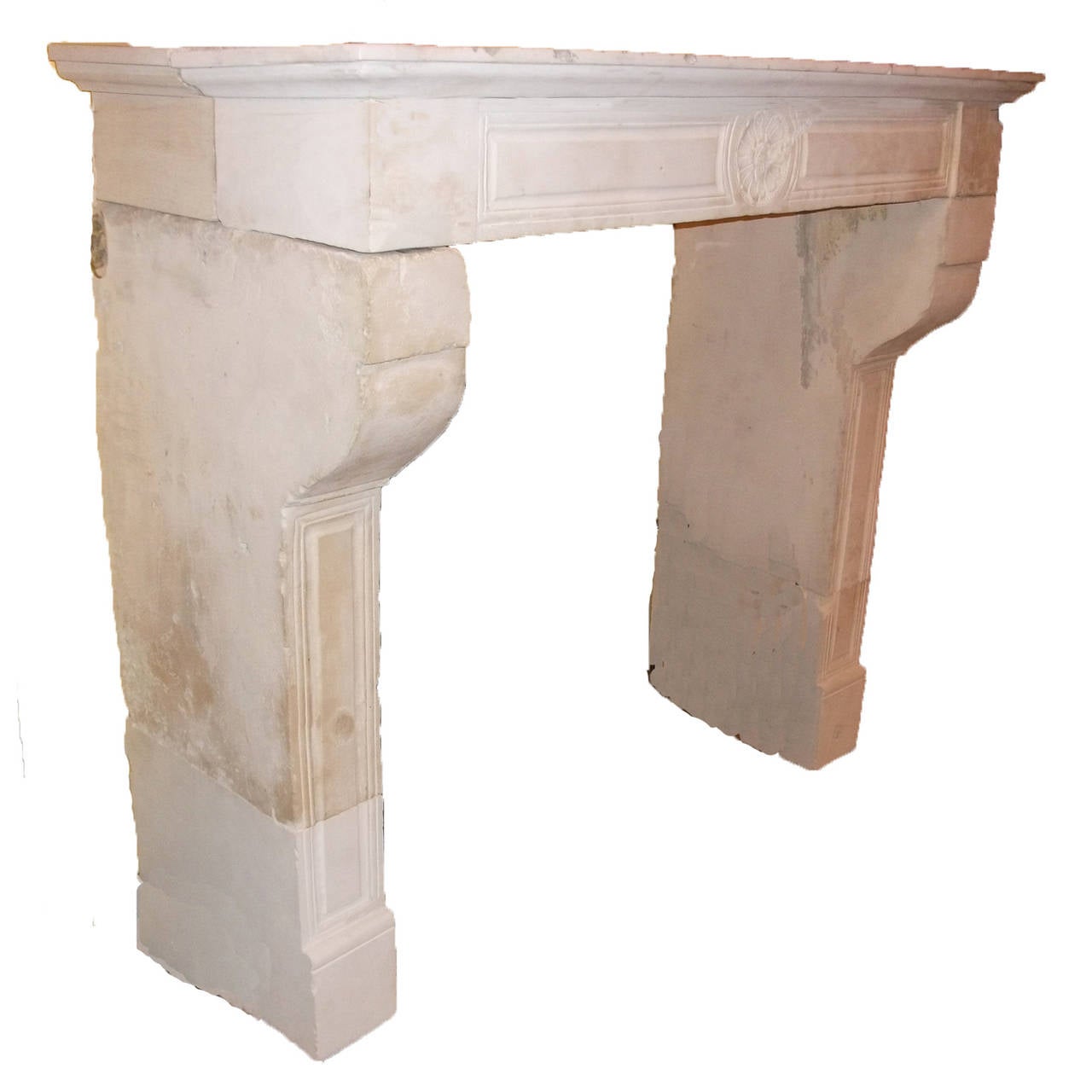 Antique French Limestone fireplace. This LOUIS XVI style fireplace is handcrafted in limestone. This limestone fireplace is in great condition and from the 18th century. Carved details on mantel and legs. Legs also have a curved accent close to