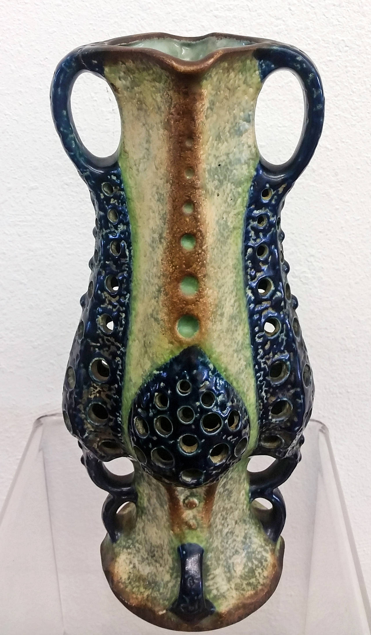 A large Amphora earthenware vase circa 1898. The unusual form based on undersea life has a yellow / cream oxidized underglaze and 4 reticulated organic cobalt handles all with burnished gold accents.

The piece is in impeccable condition with no