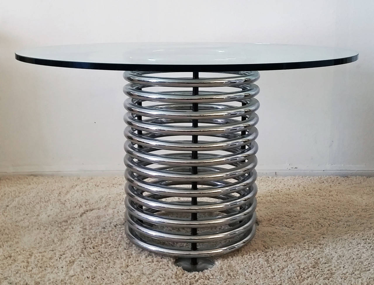 A gorgeous Italian Modern chrome and glass dining table. The table is in incredible condition with no pitting or rust-- very minimal wear to commensurate with age.

Photographed with set of 4 Thema dining chairs, also offered for sale separately.