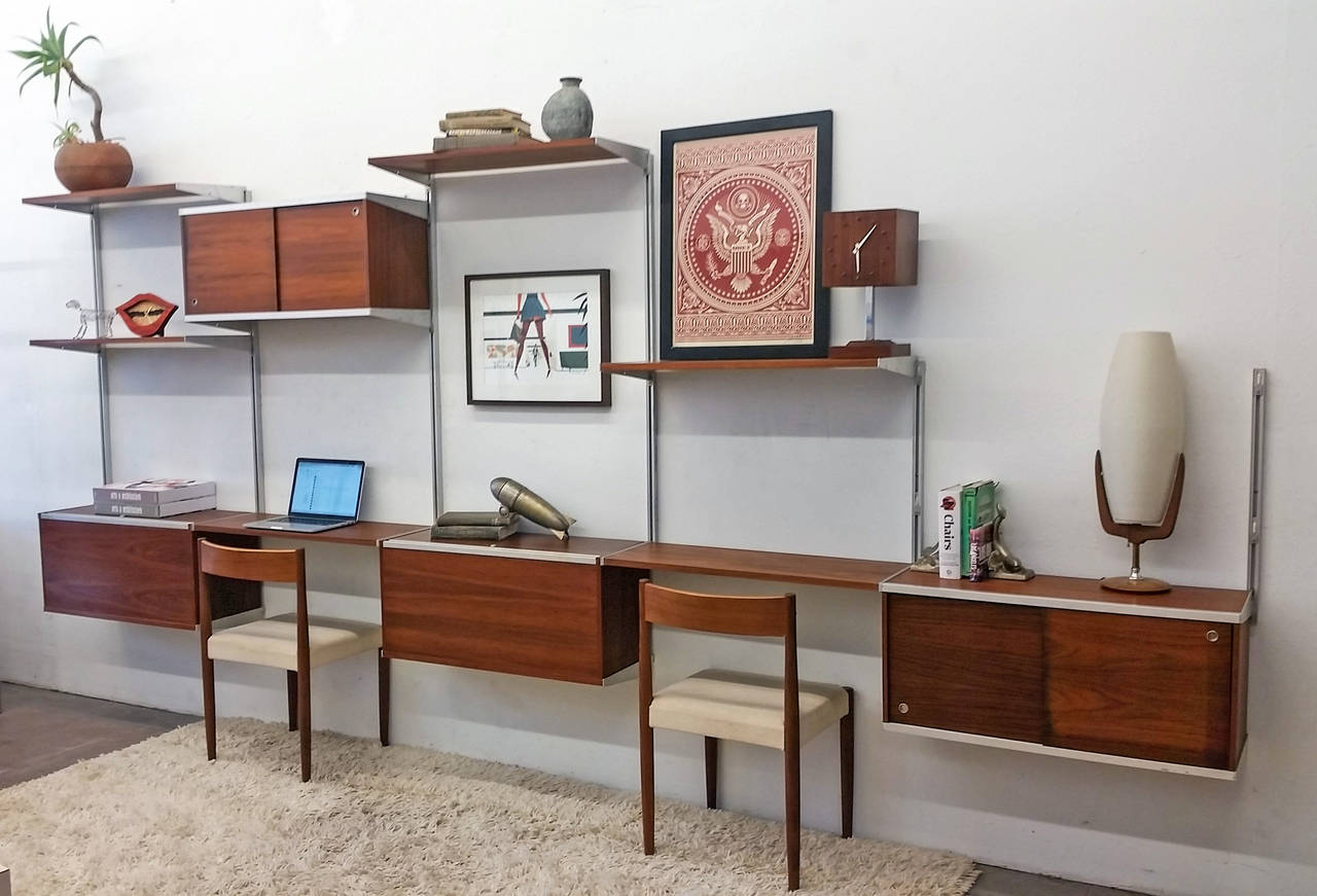 An incredible piece of Mid-Century Modern design-- this five bay walnut George Nelson wall unit was designed for Herman Miller in 1959. This early example is very large and even more stunning in person than in photographs.