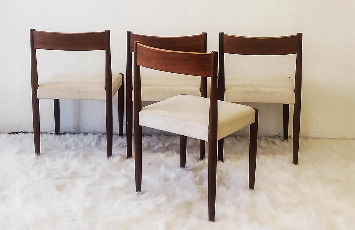A stunning set of four Poul Volther original Danish dining chairs. These chairs are in great condition and feature cream chenille type fabric upholstery.