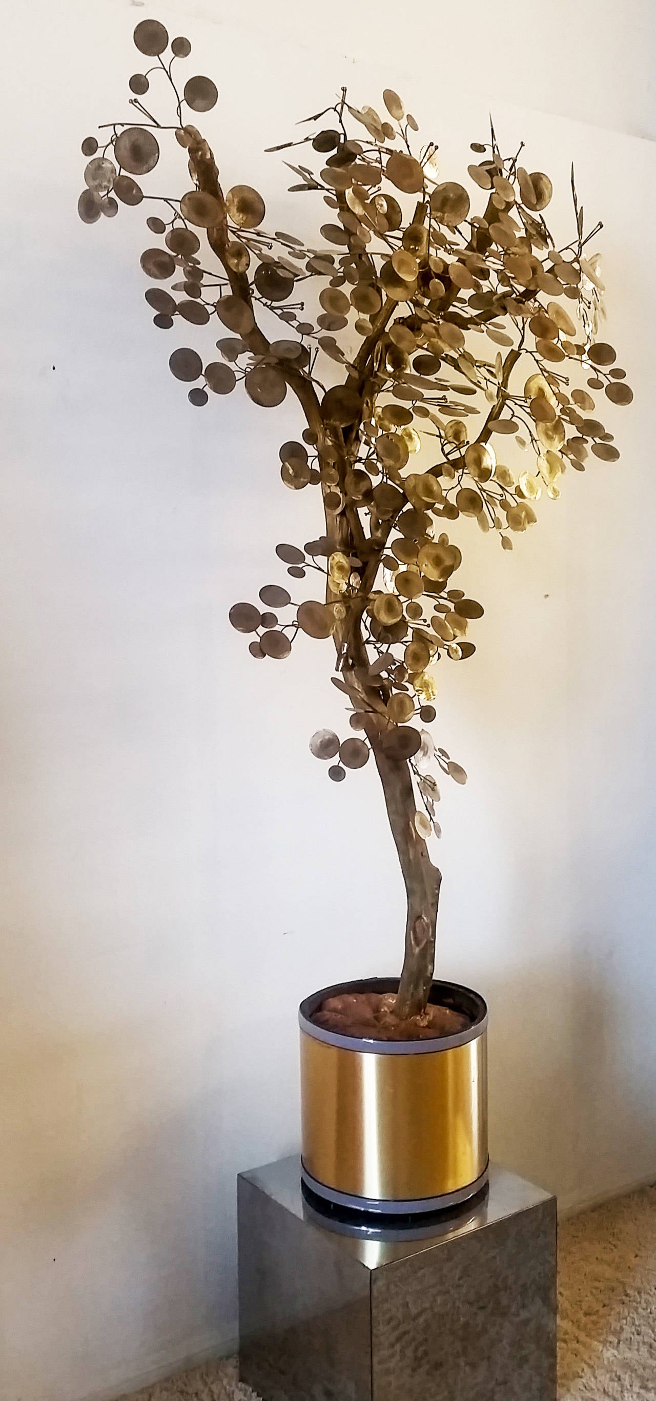This life-sized, brass tree designed by Curtis Jere is truly stunning! A part of his popular raindrop series, this wooden and brass tree stands over 6' tall and is a chic, Hollywood Regency alternative to a standard ficus tree.