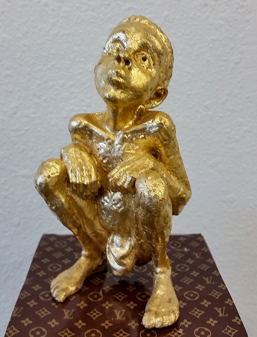 An original Beejoir gold LV child sculpture of an edition of 100. The thought-provoking sculpture is cast resin sculpture, hand finished with 24-carat gold leaf and comes in a 